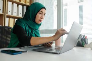 Businesswoman Working on Laptop - Check N Click Learning and Technologies Pvt. Ltd. a woman proofreading